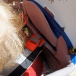 Der Sicherheitsgurt wird bei der Osprey Poco Premium hinter den Schultern des Kindes verschlossen. So ist er von oben leicht zugänglich.