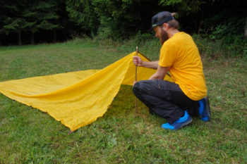 Abbildung 3: Nehme einen deiner zusammengeschobenen Stöcke oder einen ca. 50 bis 70 cm langen Ast und stelle ihn in die Mitte der kurzen Seite auf. | Foto: Flo Glott